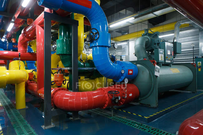 Plant cooling chamber with colorful industrial pipes — Stock Photo