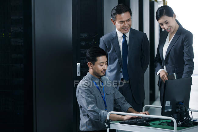 Technical personnel working with computer in the maintenance room inspection — Stock Photo