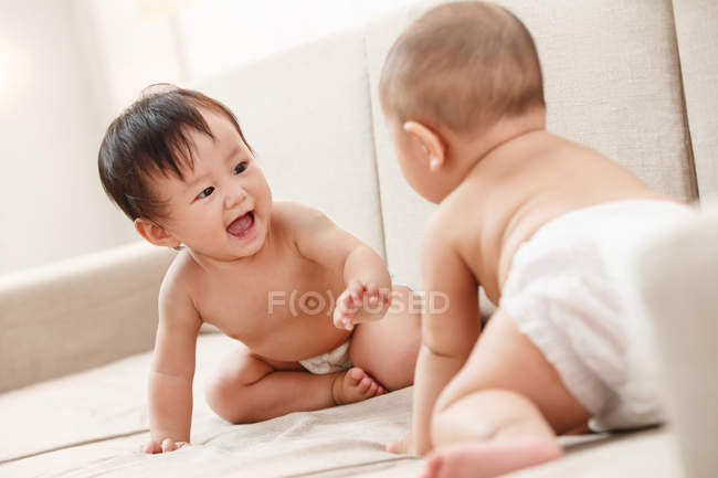 Two adorable happy asian babies playing together — Stock Photo