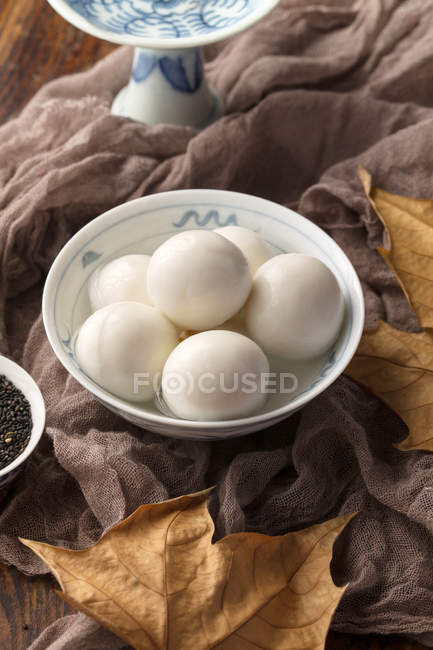 Vista de perto das tradicionais bolas de arroz glutinoso chinês e sementes de sésamo na mesa — Fotografia de Stock