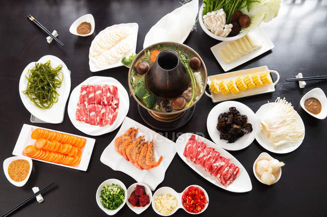Top view of various ingredients and copper hot pot, chafing dish concept — Stock Photo