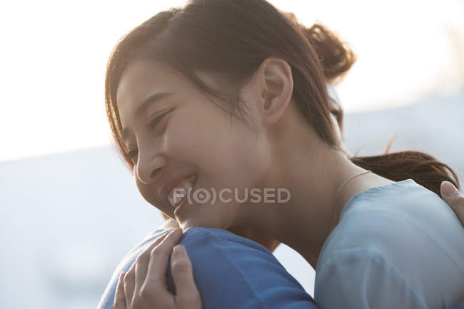 Happy elderly mother hugging young adult daughter — Stock Photo