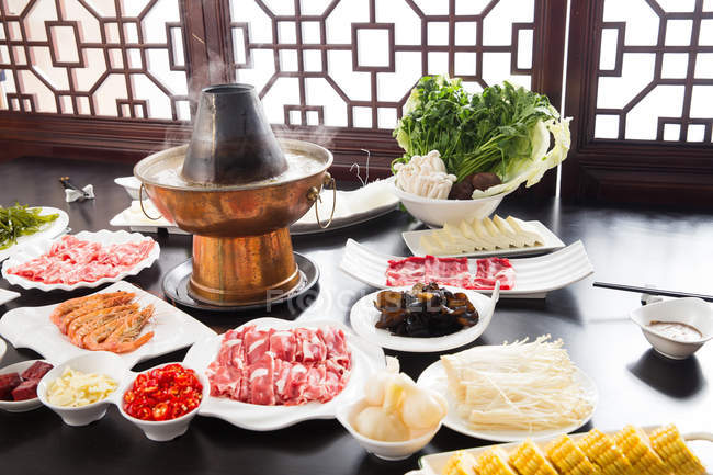 High angle view of various ingredients and copper hot pot, chafing dish concept — Stock Photo