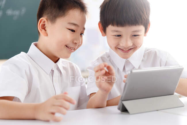 Dois alunos usando tablet digital em sala de aula — Fotografia de Stock