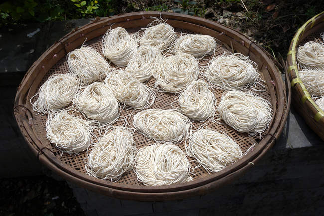 Close-up of noodles in baskets outdoors at sunny day — Stock Photo