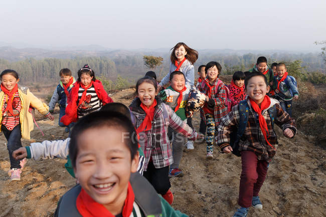 Rural female teacher and students in open air during after school activities — Stock Photo
