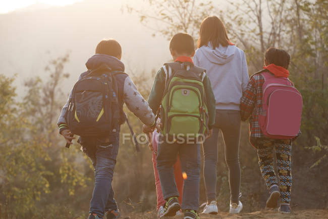 Outdoor activities for rural female teacher and students — Stock Photo
