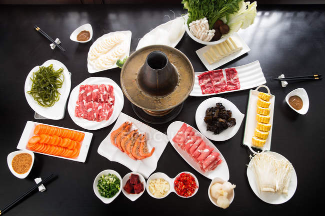 High Angle View of mutton hotpot with delicious ingredients on table — Stock Photo