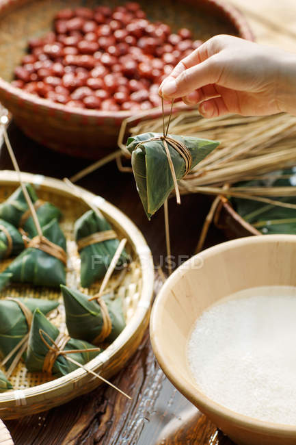 Partial view of middle-aged woman making zongzi — Stock Photo