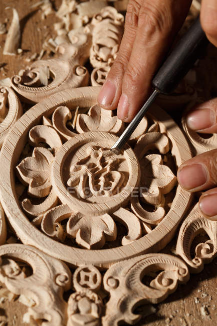 Cropped shot of asian man during woodworking engraving at workshop — Stock Photo