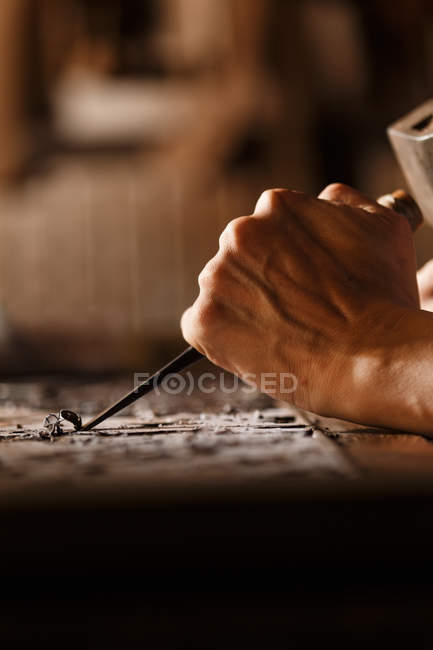 Close-up partial view of man during woodworking engraving at workshop — Stock Photo
