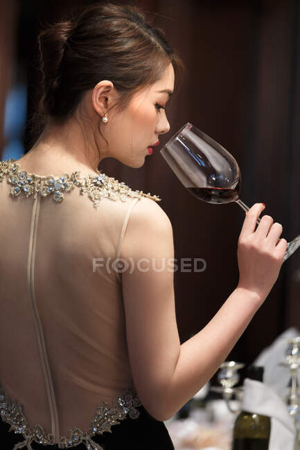 Beautiful young women drink red wine — Stock Photo