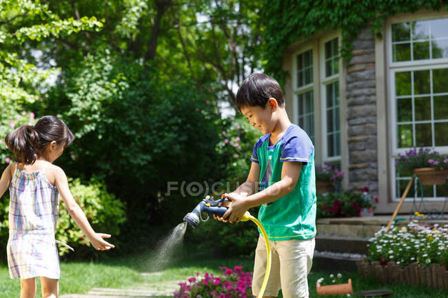 Lovely children playing in the yard. — Stock Photo