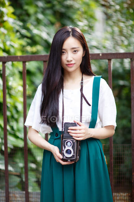 Una giovane donna con una macchina fotografica . — Foto stock