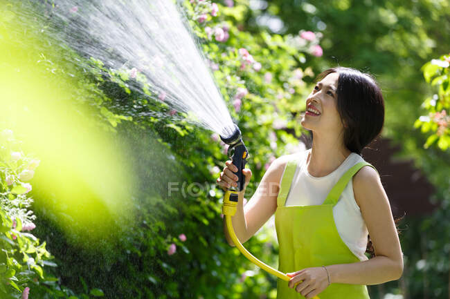 Женщины в саду поливают сад — стоковое фото