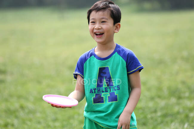 Portrait of boy playing outdoors — Stock Photo