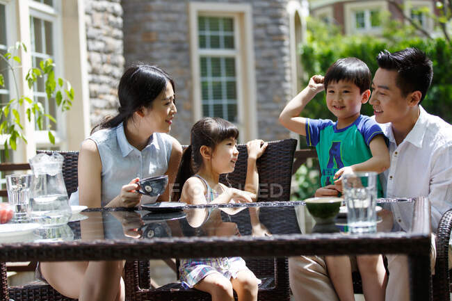 Happy family in the afternoon tea — Stock Photo