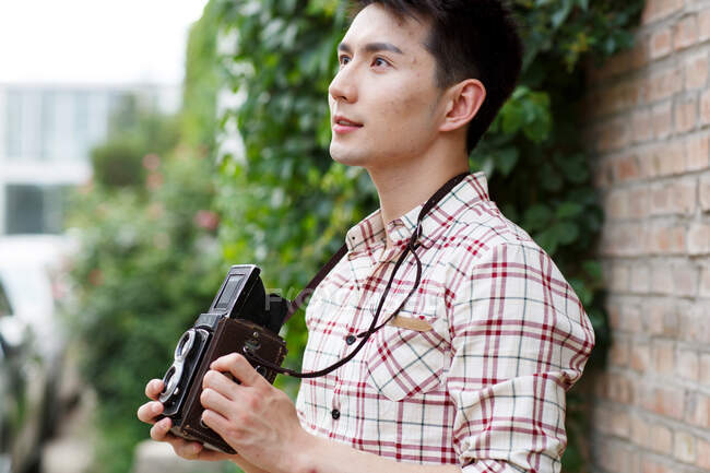Young man with a camera — Stock Photo