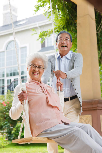 The old couple swing in outdoor — Stock Photo