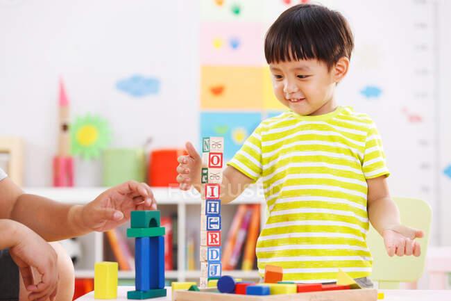 The kindergarten children playing with toys — Stock Photo