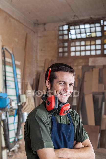 Carpenter smiling with protectors hearing — Stock Photo