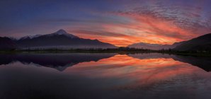 Panoramic view of Pian di Spagna flooded with snowy peaks reflected in the water at sunset Valtellina Lombardy, Italy, Europe — Stock Photo