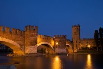 Мост Скалигеро или мост Понте Веккьо через реку Адидже возле замка Кастельвеккьо ночью, Верона, Венето, Италия, Европа — стоковое фото