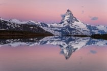 Tthe Matterhorn al amanecer reflejado en Stellisee, Zermatt valley, Zermatt, Canton of Valais, Suiza, Europa - foto de stock