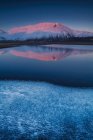 Beautiful landscape in Castelluccio di Norcia during a frozen sunset on Mount Redentore reflected in the lake, Umbria, Italy, Europe — Stock Photo