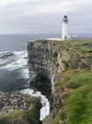 The cliffs at Noup Head with noup head lighthouseon the island of Westray in the Orkney Islands.The cliffs are extending for miles, are home to one of the largest sea bird colonies in the UK and are a RSPB Reserve. europe, central europe, northern eu — Stock Photo