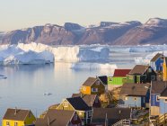 Vista del fiordo pieno di iceberg verso la penisola di Nuussuaq (Nugssuaq) durante il sole di mezzanotte. La città di Uummannaq nel nord della Groenlandia occidentale, situata su un'isola nel sistema del fiordo di Uummannaq. America, Nord America, Groenlandia — Foto stock