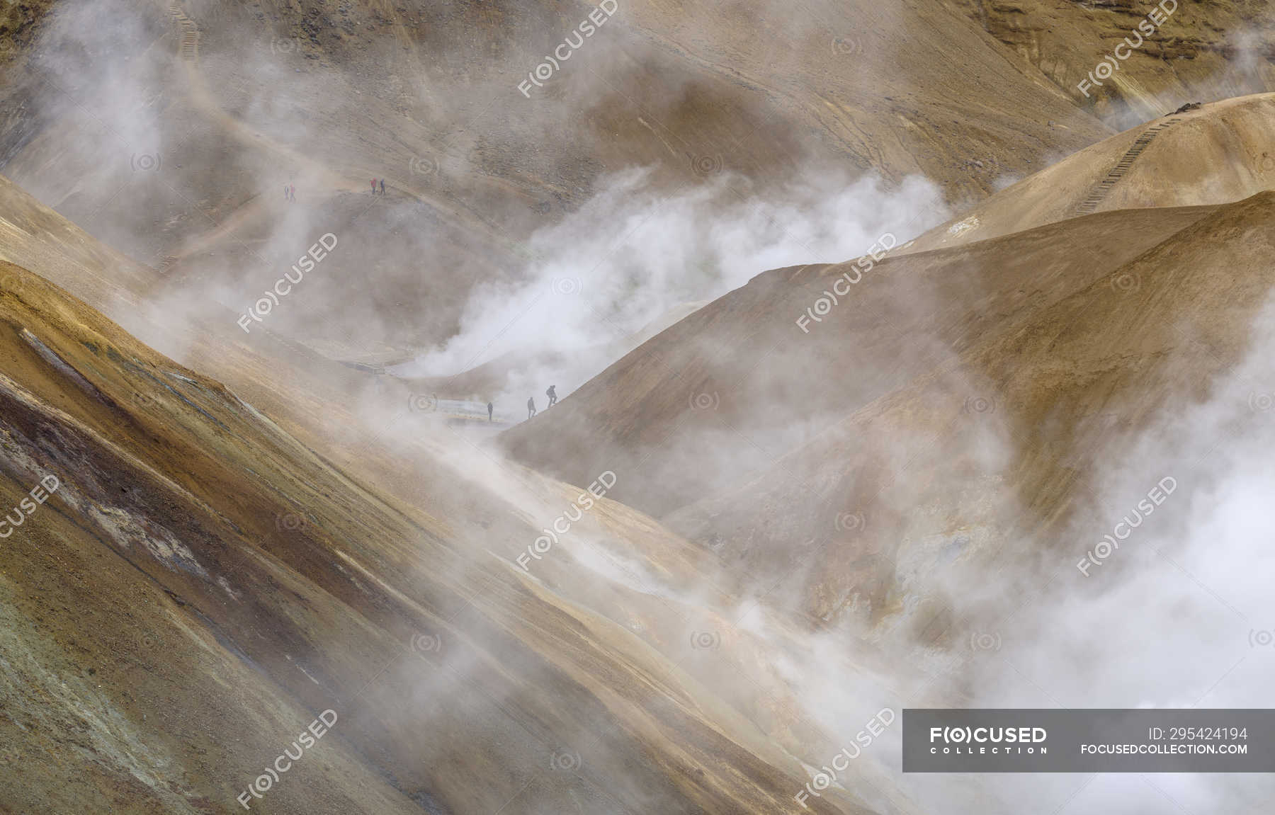 Hikers In The Geothermal Area Hveradalir In The Mountains 