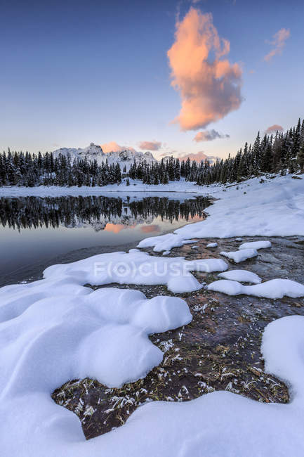 Woods and snowy peaks are reflected in Pal Lake at sunrise, Malenco Valley, Valtellina, Lombardy, Italy, Europe — Stock Photo