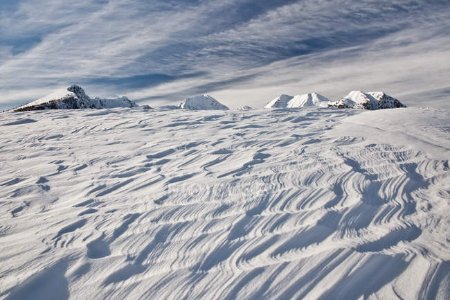 Sinuous curves in the snow shaped by the wind after a storm, Olano Alp, Rasura, Valgerola, Alps Orobie, Valtellina, Lombardy, Italy, Europe — Stock Photo