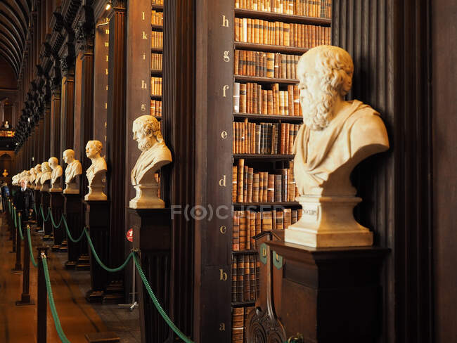 Long Room Interior Old Library Building 18th Century Trinity College Dublin Republic Of Ireland Europe People In The Background Indoors Stock Photo