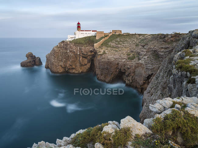 Кейп Сент-Вінсент (Cabo de Sao Vincente) зі своїм маяком на скелястому узбережжі Алгарве в Португалії. Європа, Південна Європа, Португалія, березень — стокове фото