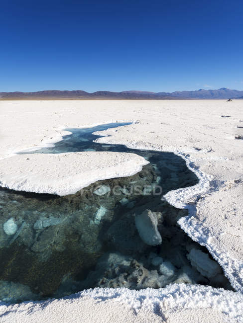 Ojos del Salar, groundwater ponds and surface of the Salar predominantly  natriumchloride.  Landscape on  the salt flats Salar Salinas Grandes in the  Altiplano. South America, Argentina — Stock Photo