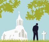 Mann besucht Friedhof in der Nähe der Kirche — Stockfoto