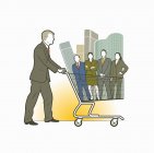 Businessman pushing shopping cart with business people and office blocks — Stock Photo
