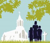 Familie besucht Friedhof nahe Kirche — Stockfoto