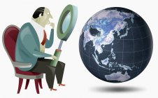 Businessman looking at globe with magnifying glass — Stock Photo