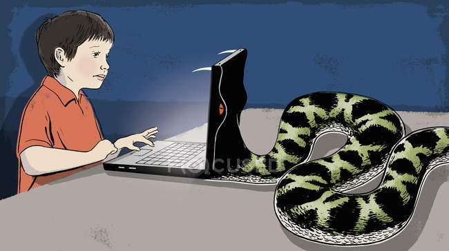 Snake eating laptop of boy — Stock Photo
