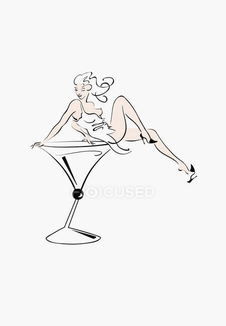 Sexy woman sitting in cocktail glass — Stock Photo