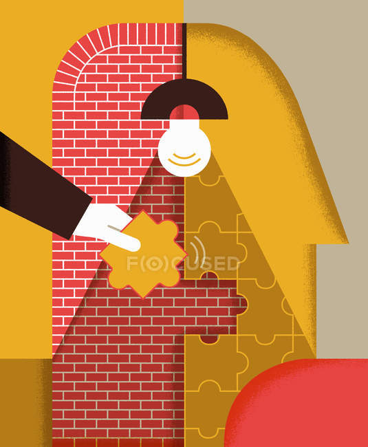 Hand assembling jigsaw puzzle on brick wall — Stock Photo