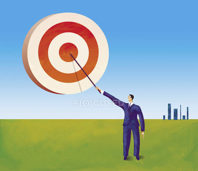 Businessman painting target in the sky — Stock Photo