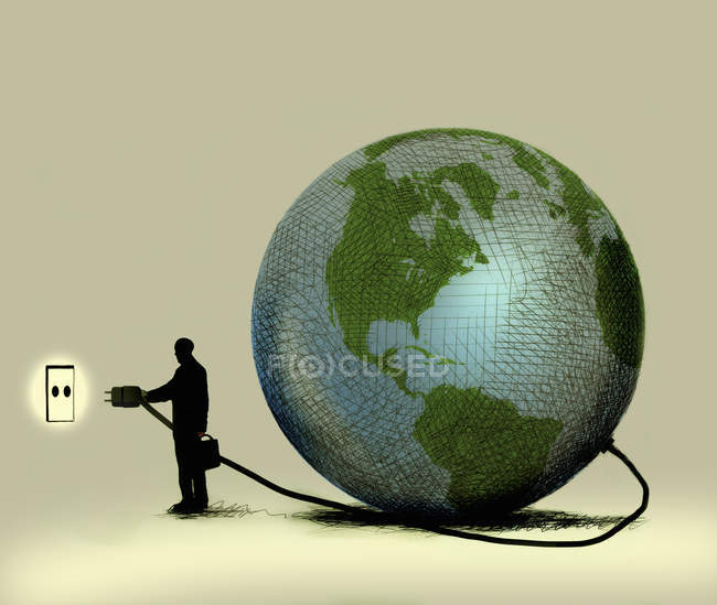 Man connecting globe to wall socket — Stock Photo