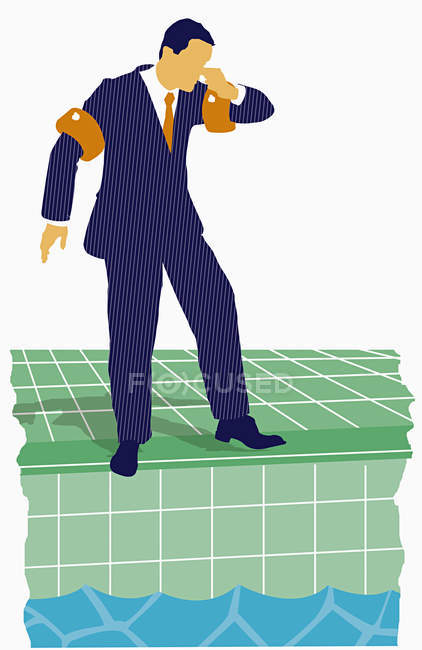 Businessman standing by swimming pool — Stock Photo