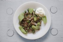 Tabule salad of red quinoa with mint and zucchini, top view. — Stock Photo