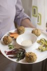 Potato and spelt no-meatballs with vegetables served with yogurt and mustard sauce. — Stock Photo