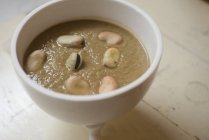 Velvety cream soup of beans in white bowl. — Stock Photo